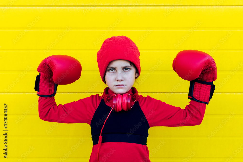 Strong girl in boxing gloves and headphones Strong girl in boxing gloves and headphones