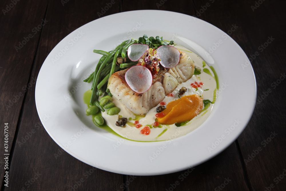 Pike perch with white sauce and beans. A white plate. Menu for the restaurant. A dish of eyelash fish. Healthy and low-calorie food.opy space. Flat lay. Pike perch with white sauce and beans. A white plate. Menu for the restaurant. A dish of eyelash fish. Healthy and low-calorie food.opy space. Flat lay.