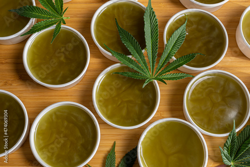 Canvas Print Making of marijuana green salve on wooden brown table