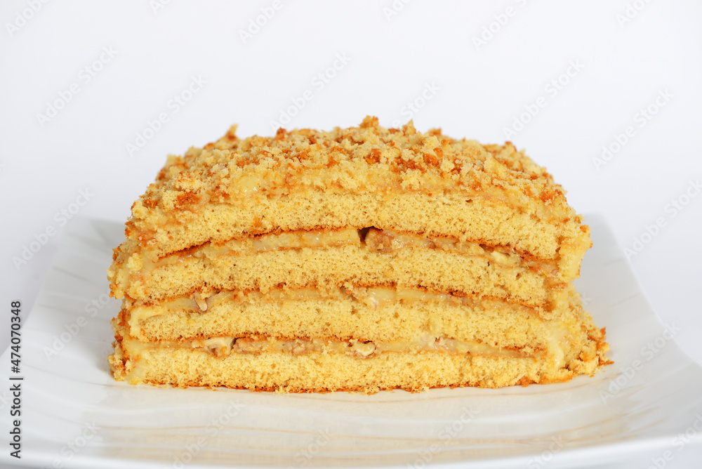 The hand-made custard honey cake with walnuts inside The hand-made custard honey cake with walnuts inside