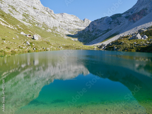 Reflection of mountains in emerald-green Lake Partnun in Praettigau  Graubuenden  Switzerland.