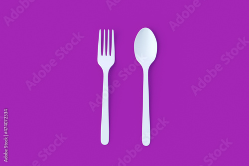 White spoon and fork on violet background. Top view. 3d render