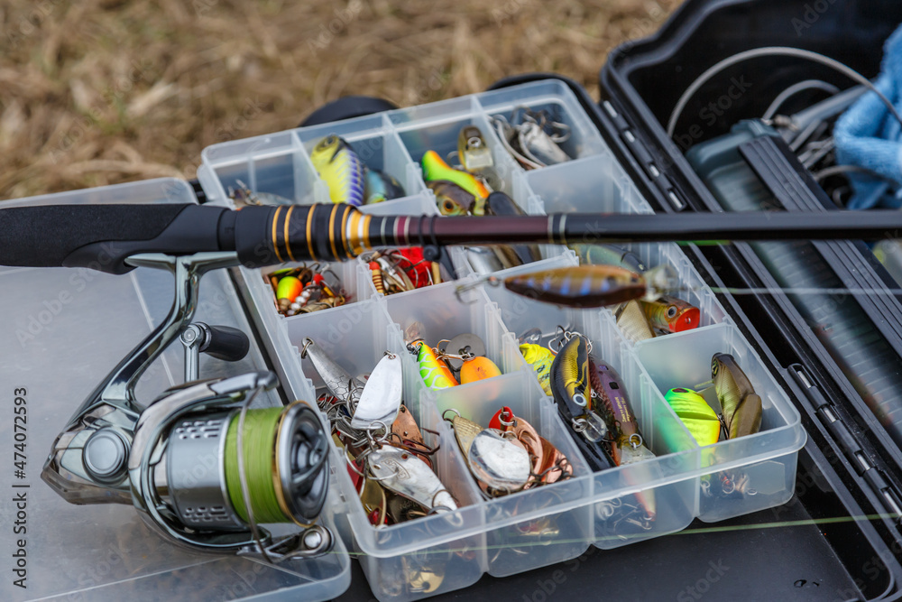 A large fisherman's tackle box fully stocked with lures and gear