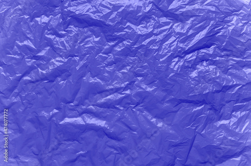 Abstract background. Crumpled plastic surface. Color of the year 2022 Very Peri.