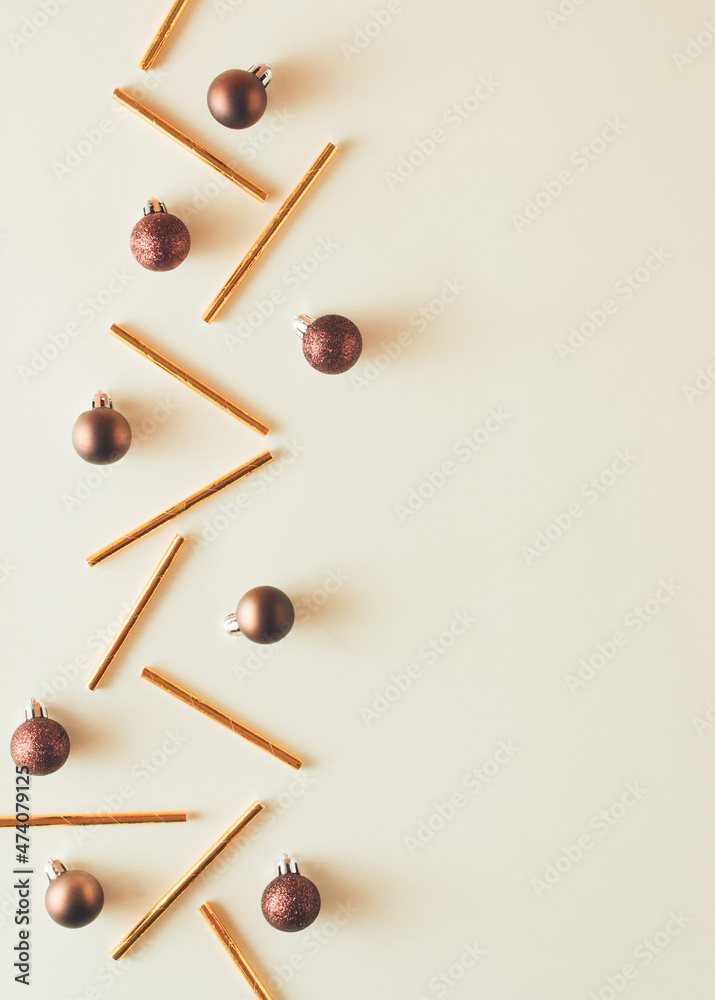 Minimal New Year concept. Christmas brown balls with gold straws on pastel yellow backgorund. Creative copy space. Minimal New Year concept. Christmas brown balls with gold straws on pastel yellow backgorund. Creative copy space.