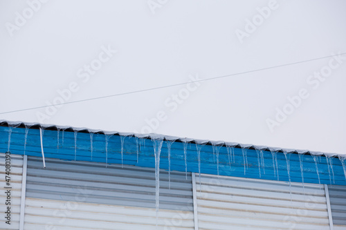 Icicles hanging from the roof.