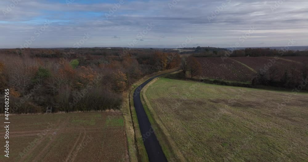 Aerial shot above a road going threw trees in Touraine, France. Aerial shot above a road going threw trees in Touraine, France.