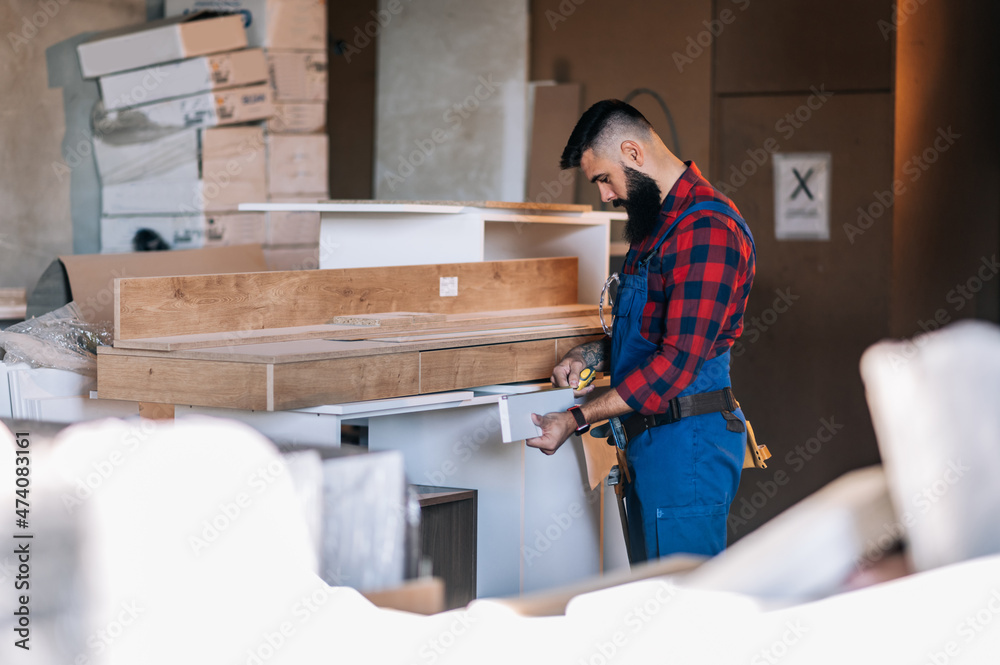 Young male carpenter working in workshop Young male carpenter working in workshop