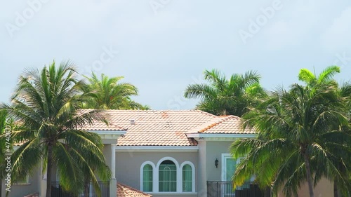 Miami, Florida real estate property modern mansion luxury villa house closeup in Hollywood and Hallandale beach Three Islands neighborhood with palm trees on sunny day and sky