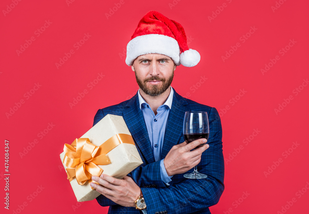 mature bearded man in santa hat celebrate new year or christmas, corporate party. mature bearded man in santa hat celebrate new year or christmas, corporate party.