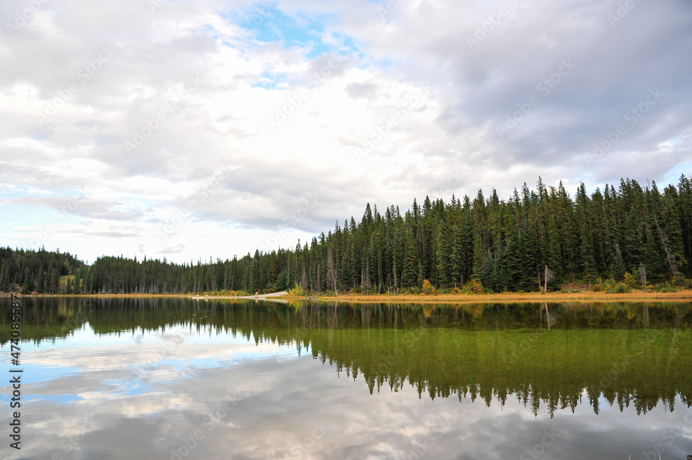 Goldeye lake reflection of campground and mountain park grass green water, near Nordegg, Alberta, Canada Goldeye lake reflection of campground and mountain park grass green water, near Nordegg, Alberta, Canada