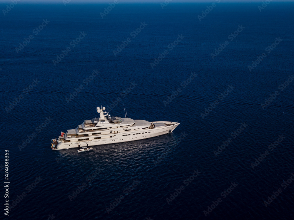 Aerial view on white yacht in blue sea