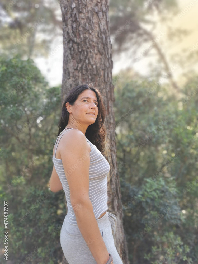 Happy spanish middle-aged woman posing in the forest Happy spanish middle-aged woman posing in the forest