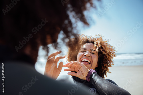 Woman applying sunscreen on the beach photo