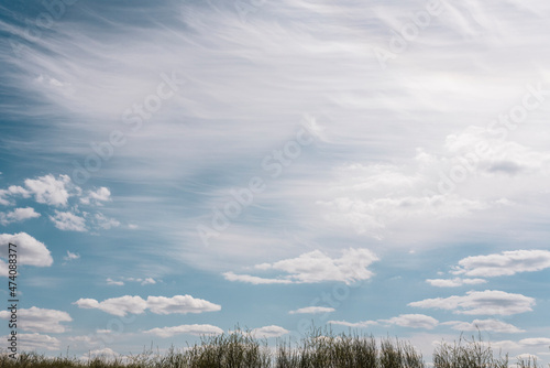 Wispy Clouds in Blue Sky photo