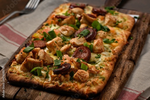 Rustic Pizza over a pice of wood photo