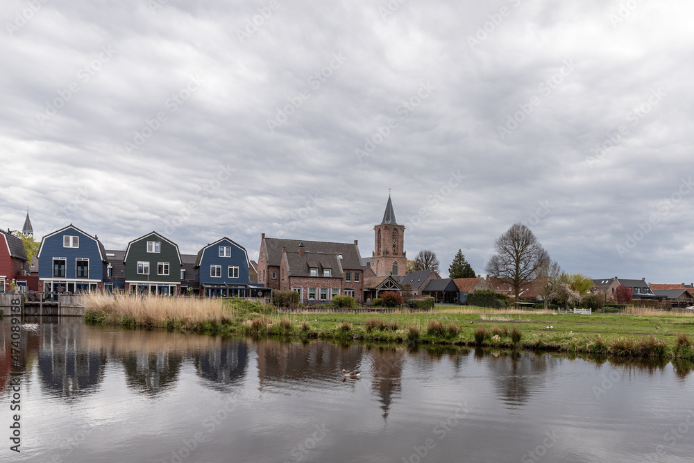 Church and colored houses in the village of Bunschoten-Spakenburg. 