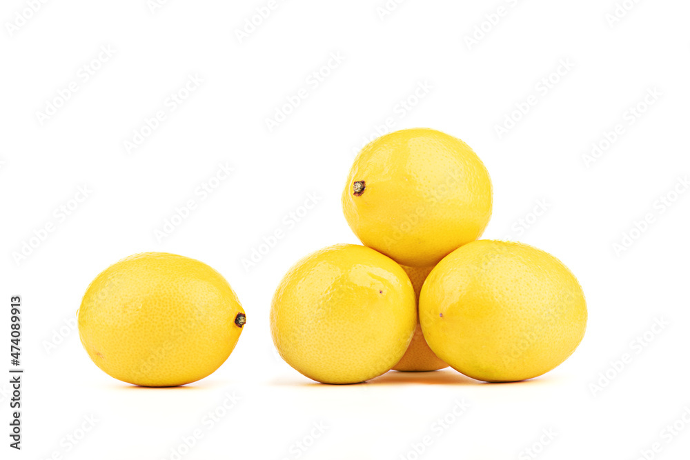 Ripe lemons stacked in a pyramid one separately on a white background. Ripe lemons stacked in a pyramid one separately on a white background.