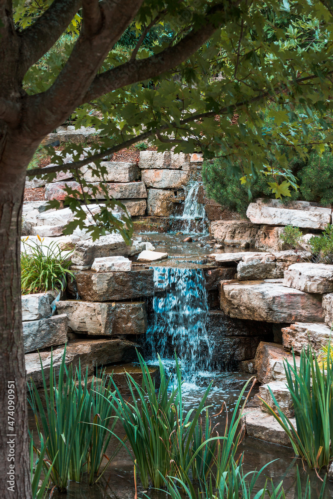 Small waterfall in a garden during the summer Small waterfall in a garden during the summer