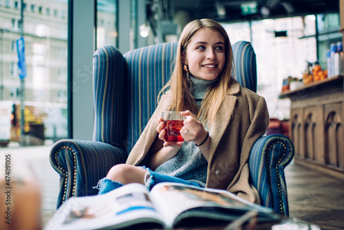 Cheerful woman drinking hot tea