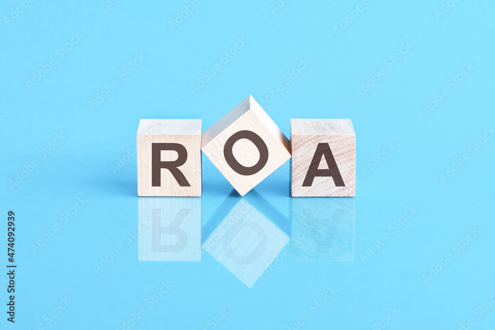 ROA - acronym from wooden blocks with letters, front view on blue background ROA - acronym from wooden blocks with letters, front view on blue background