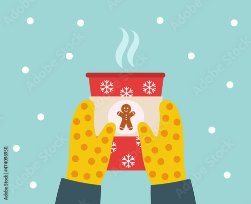 Christmas coffee or hot chocolate in hands in mittens.