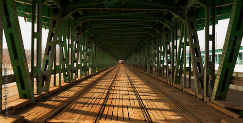 train tracks leading inside the bridge