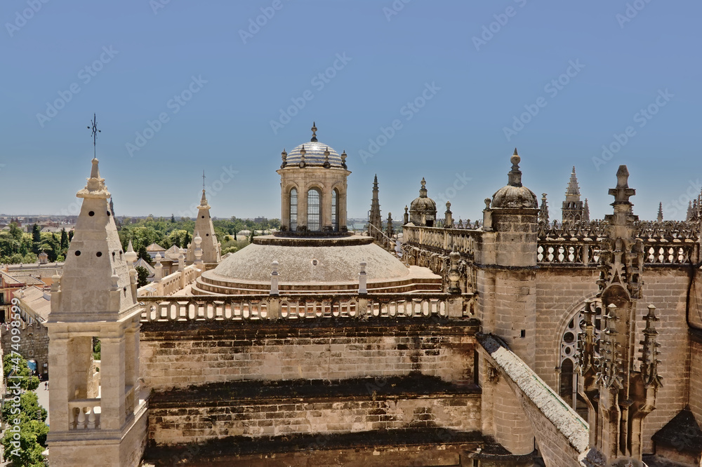 Ornate roofs s of the CCathedral of Saint Mary of the See in ornate gothic style in Seville, Spaiin. 