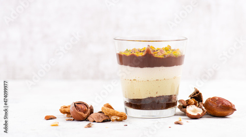 Dessert with chocolate cream, cake and nuts in a glass, sweet food, christmas season