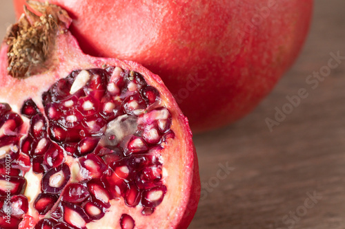 Pomegranate fruit on wooden board. Close-up.