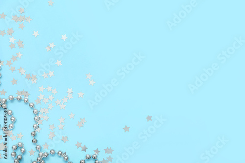 Beautiful confetti and beads on blue background