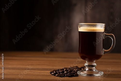 Espresso and coffee beans on the table.