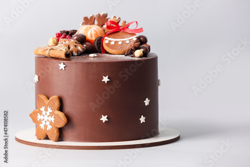 Stand with tasty Christmas chocolate cake on light background