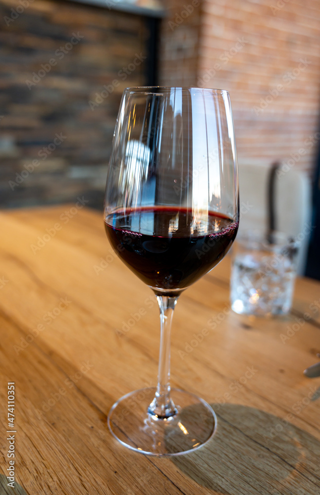 Glass of dry red wine served in cafe