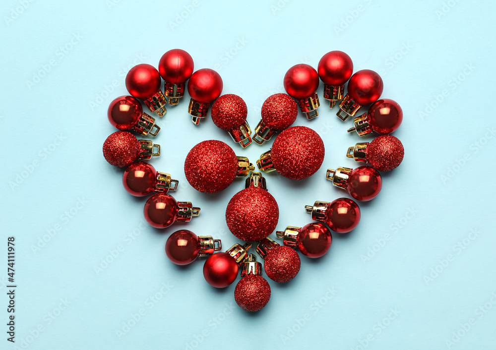Heart made of Christmas balls on blue background Heart made of Christmas balls on blue background
