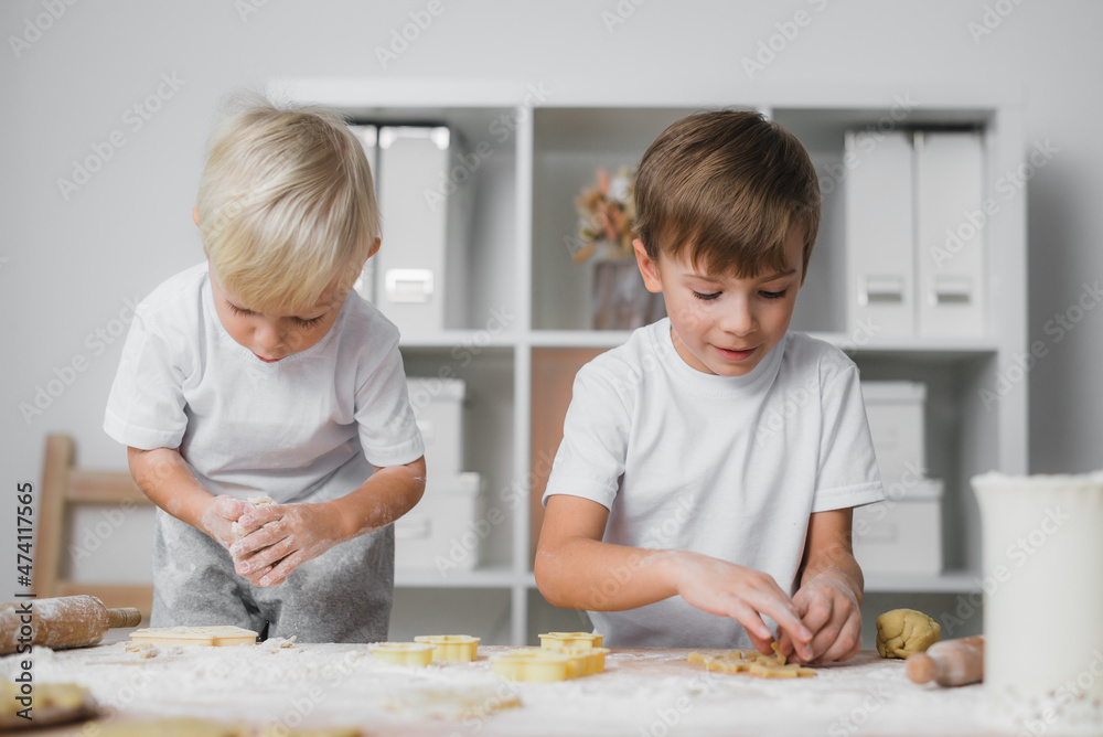 Children are enthusiastically engaged in the preparation of sweets - cookies. Children are enthusiastically engaged in the preparation of sweets - cookies.