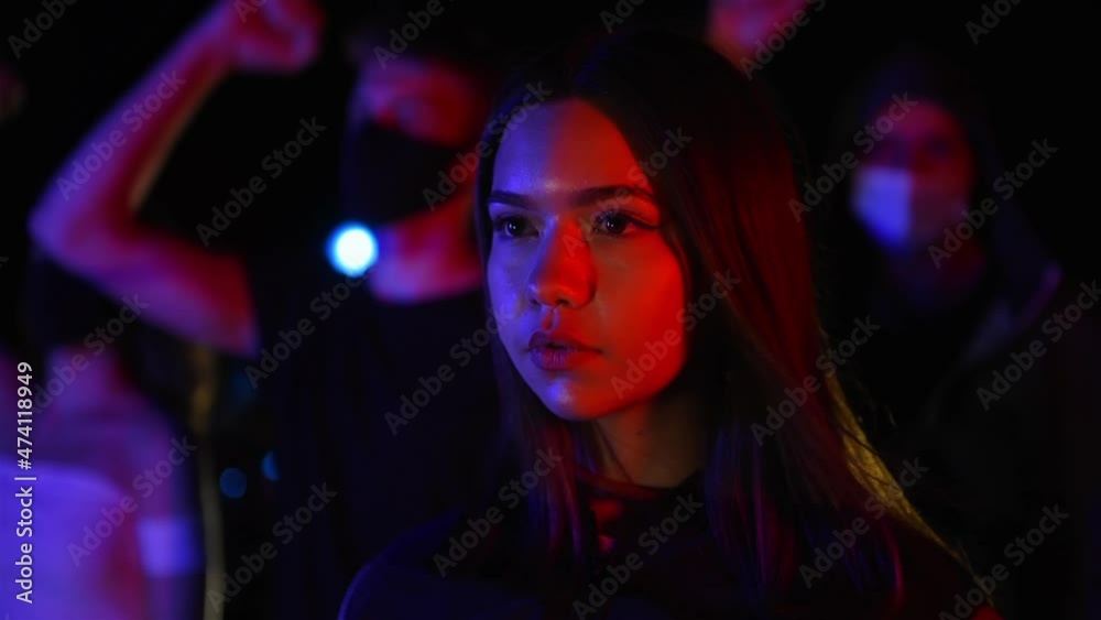 Close up view of woman. Group of protesting young people that standing together. Activist for human rights or against government Close up view of woman. Group of protesting young people that standing together. Activist for human rights or against government