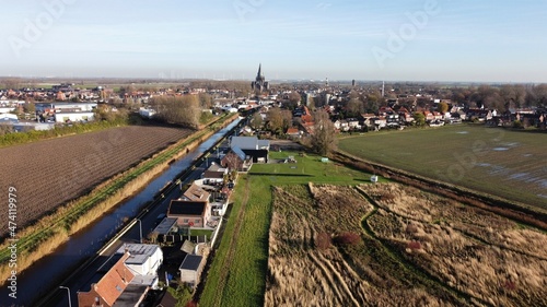 Steenbergen in Brabant, Netherlands with the well-known characteristic Roman Catholic Church Saint Gummarus from 1901 in Gothic style fairytale-like on the horizon.