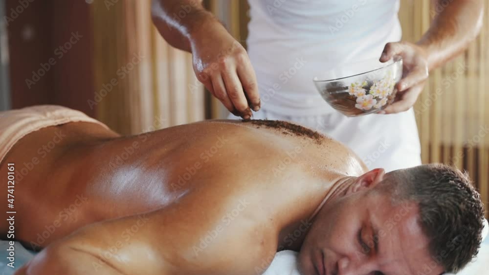 Young adult man relaxing with hand massage at beauty spa