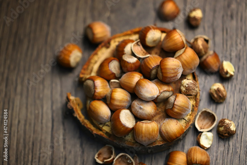 Selective focus. Hazelnuts, peeled and peeled on a wooden surface.