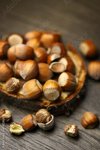 Selective focus. Hazelnuts, peeled and peeled on a wooden surface.