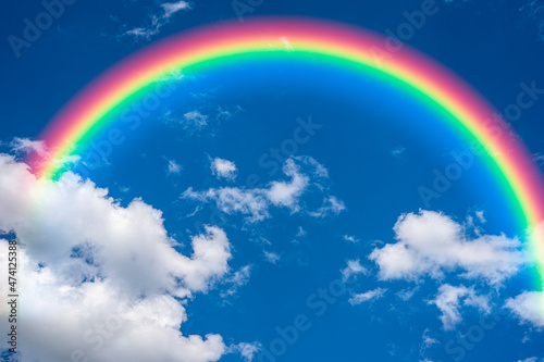 rainbow in the blue sky background © pushish images