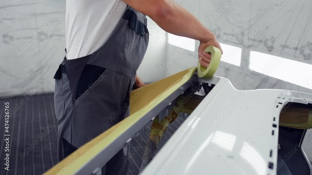 Professional repairman in garage works with automobile parts Professional repairman in garage works with automobile parts