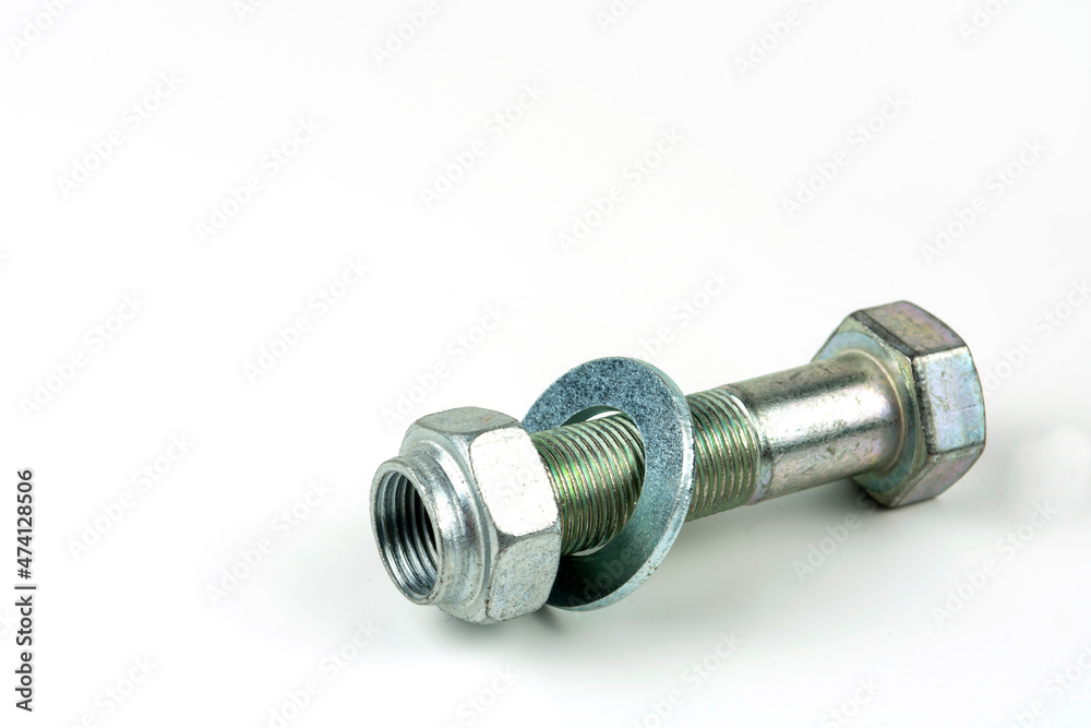 Large metal nuts with silver metal bolts. Close-up on a white background. A group of several nuts and bolts Large metal nuts with silver metal bolts. Close-up on a white background. A group of several nuts and bolts