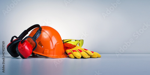 Work safety protection equipment on grey background with copy space. Horizontal banner. photo