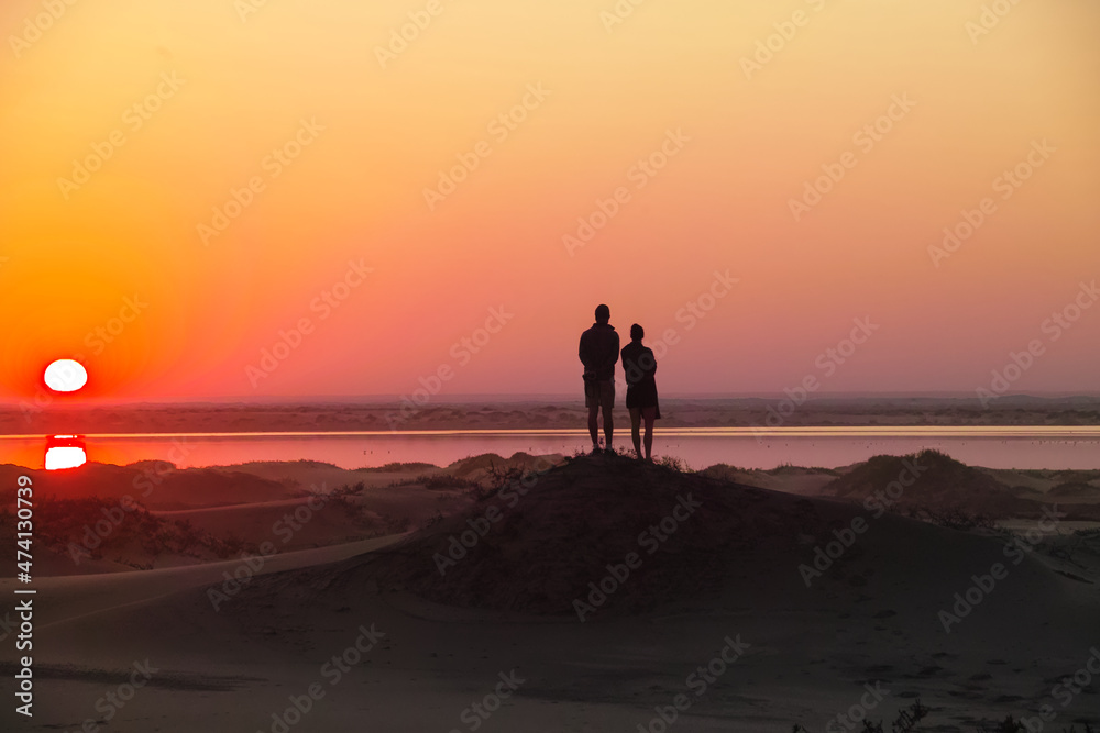 Two people looking at a sunset/sunrise in the Namib desert