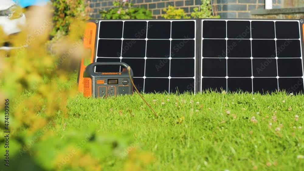 Solar Generator With Portable Solar Panels In Green Meadows. Closeup
