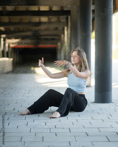 The girl dances beautifully under the bridge