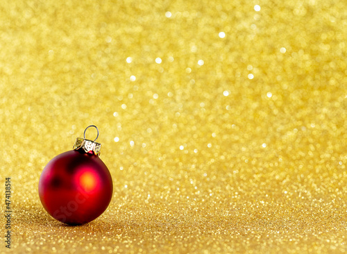 Red Christmas Tree Ball on Yellow Background with Bokeh.