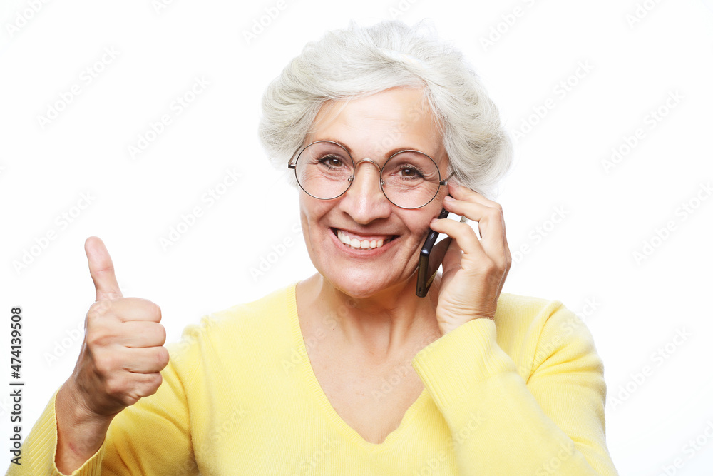 Photo of crazy ecstatic old woman use smartphone impressed social media like feedback win thumb up Photo of crazy ecstatic old woman use smartphone impressed social media like feedback win thumb up